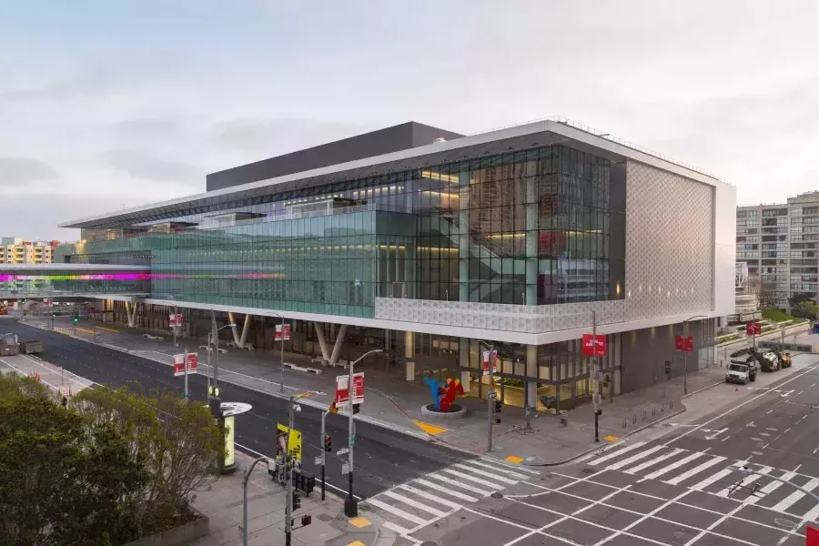 A wide shot of the glassy, modern Moscone Center South building.